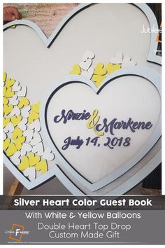 a heart shaped guest book with yellow and white balloons