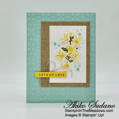 a close up of a card with flowers on the front and bottom, which reads lots of love