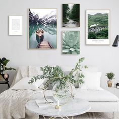 a living room filled with white furniture and pictures on the wall above it's coffee table