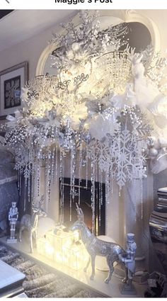 a fireplace with snowflakes hanging from it's mantle and reindeer figurines