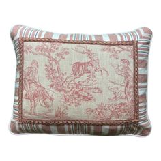 a pink and white striped pillow with horses on it's side, in front of a