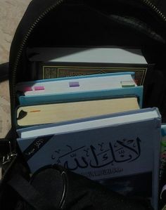 a backpack filled with books sitting on top of a floor