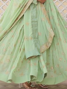 Introducing our stunning "precious pista green sequins georgette engagement wear anarkali gown," the perfect outfit for your special occasions. This exquisite gown comes in a beautiful pista green color with intricate zari embroidery and sequin work, adding a touch of elegance and glamour to your look. The gown is fully stitched and available in sizes ranging from XS to XXL, ensuring a perfect fit for every body type. With a 3.5-meter flair and a length of 56 inches, this gown is sure to make yo Green Embroidered Party Wear Dupatta, Green Bollywood Gown With Intricate Embroidery, Green Chinon Anarkali Set With Mirror Work, Bollywood Green Gown With Intricate Embroidery, Bollywood Style Green Gown With Intricate Embroidery, Green Chinon Sharara For Party Wear, Green Floor-length Anarkali Set With Mirror Work, Pista Green Chinon Salwar Kameez For Reception, Green Salwar Kameez With Mirror Work For Reception