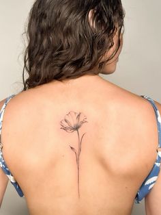 a woman with a flower tattoo on her back