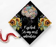 a graduation cap decorated with sunflowers and an image of a brain