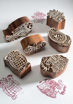 six wooden stamps with intricate designs on them