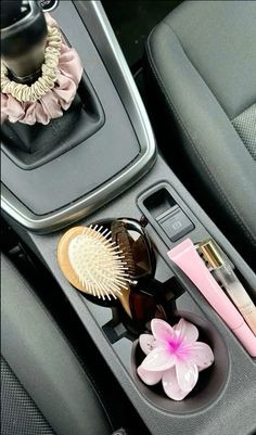 the interior of a car with various items in it, including a hair brush and comb