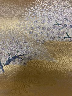 an abstract painting with flowers and trees on gold foiled paper, as well as the background