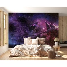 a bedroom with a large wall mural in the center and purple galaxy on the other side