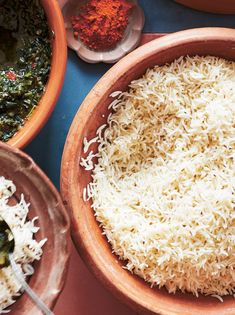 bowls filled with rice and other foods on a table