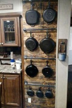 a kitchen with pots and pans hanging on the wall