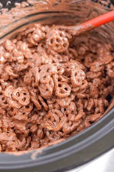 a bowl full of chocolate cereal with a spoon in it