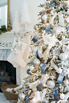 a white christmas tree with blue and silver ornaments