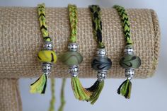 four different bracelets with tassels and beads