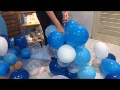 blue and white balloons are on the table