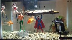 some action figures are standing in an aquarium