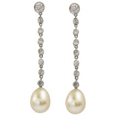 A pair of Edwardian pearl and diamond drop earrings, each earring with a tear-drop shaped pearl, accompanied by GCS report stating to be natural saltwater, suspended by a run of nine old European and Swiss-cut diamonds, the diamonds estimated to weigh 0.6 carats in total, millegrain-set i with peg fittings in 18ct white gold, circa 1910, measuring approximately 3.6 x 0.6cm, gross weight 3 grams. Edwardian earrings in Very Good condition. Unmarked tested as 18ct Gold. A graceful pair of pearl ear Edwardian Earrings, Vintage Drop Earrings, Pearl Jewels, Tiny Diamond, Be Natural, Diamond Drops, Diamond Drop Earrings, Earrings Drop, Pearl Diamond