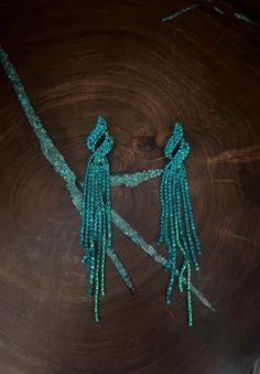 Teal green long fringe earrings  Size: .75 wide by 4 inches long Green Beaded Fringe Earrings For Party, Green Chandelier Earrings For Evening, Green Tassel Earrings For Party, Green Tassel Dangle Earrings, Green Fringe Tassel Earrings For Party, Green Beaded Fringe Jewelry For Party, Turquoise Earrings For Evening, Elegant Green Earrings With Beaded Fringe, Glamorous Green Dangle Chandelier Earrings