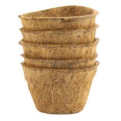 a stack of straw baskets sitting on top of each other in front of a white background