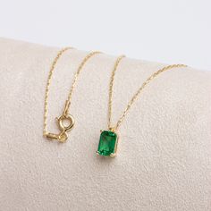 "Emerald; It is considered to be a stone of love, sensitivity and loyalty. It is seen as a symbol of harmony in relationships. Our rectangular emerald necklace, with its minimalist design, is a jewel that you can use daily and on special occasions. It is a nice gift for yourself and your loved ones. The birthstone of those born in May is emerald. 🔸🔸 Our elegant, style and stylish products suitable for special occasions and daily use are produced with love and care for you and your loved ones. Yellow Gold Necklace With Rectangular Stone For Anniversary, Elegant May Birthstone Necklace With Rectangular Stone, Rectangular Emerald Necklace For May Birthstone, Yellow Gold Emerald Jewelry With Rectangular Stone, Emerald Cut 14k Gold Necklace For Gift, Rectangular Emerald Birthstone Jewelry, Fine Jewelry Necklaces With Rectangular Gemstone, Minimalist May Birthstone Jewelry In Rectangular Shape, May Birthstone Necklace With Rectangular Stone For Gift