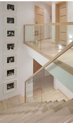 a staircase with pictures on the wall next to it