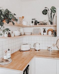 the kitchen counter is covered with pots and pans as well as dishes on shelves