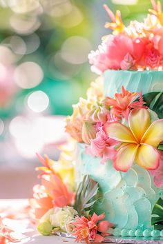 a multi layer cake with flowers on top