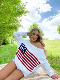 Show your patriotism with style! Our American Flag Crochet Sweater is the perfect way to rock the patriotic look and stay cool in the summer heat. Crafted with love, this boat neck flag crochet knit sweater comes in white and beige, with ribbed trim and 100% cotton fabric, making it the ideal companion for lake days, beach trips, and other outdoor adventures. Get yours today and show your American pride in style! Mary Ashlee is wearing a small / medium Crochet knit American flag sweater Patriotic & perfect for the summer! Comes in white, beige, light pink, & light blue Ribbed trim Runs very true to size Pair with jean shorts or comfy joggers for a casual, relaxed look Made of 100% cotton American Flag Sweater, Girls Snow Boots, Party Blouse, American Pride, Kendall Jenner Style, Unique Crochet, Kids Sleepwear, Inspiration Mode, Crochet Sweater