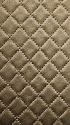 an up close view of a quilted material with diamond pattern on the back and sides