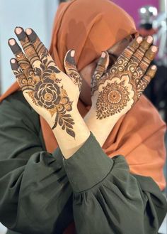 a woman with her hands decorated with henna