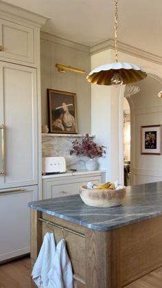 a large kitchen island with a bowl on it and an umbrella hanging from the ceiling