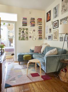 a living room filled with furniture and pictures on the wall