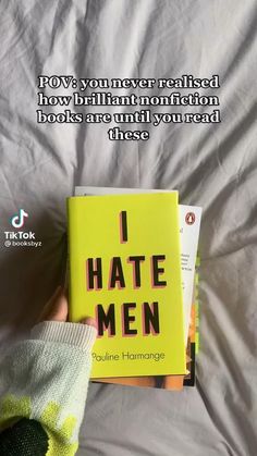 someone is reading a book in bed with the caption i hate men written on it