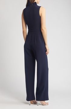 A frilled neckline adds festive flair to a one-and-done jumpsuit painted in a classic shade of navy blue. 59 1/2" length; 31" inseam; 22 1/2" leg opening (size 8) Hidden back-zip closure V-neck Sleeveless Partially lined 97% polyester, 3% spandex Hand wash, dry flat Imported Elegant Strapless Jumpsuit For Work, Elegant Fitted Navy Jumpsuits And Rompers, Navy Sleeveless Fitted Jumpsuits And Rompers, Navy Fitted Elegant Jumpsuits And Rompers, Elegant Fitted Navy Jumpsuit, Navy Fitted Elegant Jumpsuit, Chic Navy Jumpsuit For Work, Chic Navy Sleeveless Jumpsuits And Rompers, Eliza J