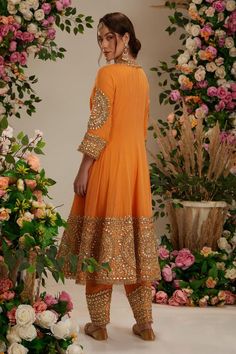 Peach orange georgette long anarkali with intricate gota work in floral pattern. Comes with matching salwar and pure organza dupatta.
Components: 3
Pattern: Embroidered
Type Of Work: Gota
Neckline: Round
Sleeve Type: Three Quarter
Fabric: Anarkali and Salwar: Georgette, Dupatta: Organza
Color: Peach,Orange
Other Details: 
Embellished show buttons
Kiran border dupatta
Model height: 5ft 7inches, wearing size S
Closure:
Kurta: Front hook and eye
Salwar: Drawstring tie-up
Occasion: Wedding,Puja - Az Orange Chanderi Sharara For Reception, Orange Sharara With Resham Embroidery For Reception, Orange Anarkali Set For Reception And Festivals, Orange Dupatta For Reception And Festivals, Orange Chanderi Dupatta For Reception, Orange Traditional Wear For Diwali Reception, Orange Traditional Wear For Reception And Diwali, Orange Dupatta With Gota Work For Reception, Orange Mirror Work Dupatta For Reception