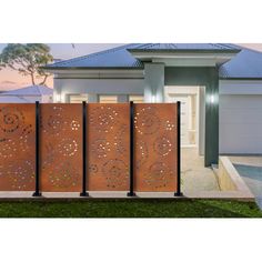 three metal gates in front of a house