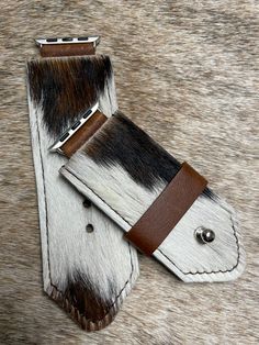 "Cowhide with leather backing. Message me with your hide preference, if not available order will be filled with something similar. Band is approximately 1.5\" wide. Cowhide is a product of an animal, the hide may wear or shed. Can be personalized for a fee." Cow Hide Print Bracelets, Brown Rectangular Watch Strap, Brown Rectangular Wrist Strap For Watches, Brown Rectangular Bracelet Strap Watch Accessories, Brown Leather Strap Apple Watch Band, Brown Rectangular Watch Accessories With Bracelet Strap, Brown Leather Strap For Watch Accessories, Leather Apple Watch Band, Leather Apple Watch