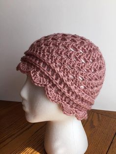 a crocheted hat is shown on a mannequin head