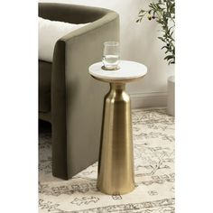 Introducing the Kate and Laurel Cardina round drink table, a captivating blend of modern glam and natural elegance. The striking combination of the white marble tabletop and the gold base creates a luxurious aesthetic that is sure to impress. The tabletop is crafted from authentic marble to create a modern aesthetic, while the base is crafted from sturdy iron. This charming cocktail table is a beautiful accent for serving and placing drinks when friends are around due to its sturdy metal base. I Luxurious Aesthetic, Bedroom Nightstand, Living Room Plants, Modern Marble, Modern Tops, Modern Glam, Marble And Gold, Mini Table, Drink Table