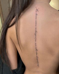 the back of a woman's neck with writing on her left shoulder and lower back