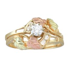 a gold ring with leaves and diamonds on it