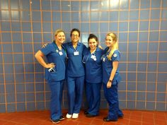 three women in scrubs standing next to each other with their arms around one another