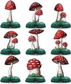 a group of red and white mushrooms sitting on top of each other next to each other