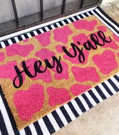 a door mat with the words hey yae on it and hearts in black letters