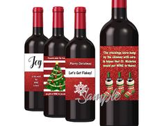 three bottles of red wine with christmas decorations on the label, and one bottle is empty