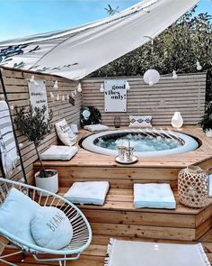 a hot tub sitting on top of a wooden deck