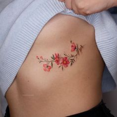 a woman's stomach with pink flowers on it