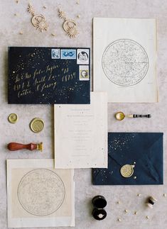 an assortment of personal items are laid out on a table with gold and black ink