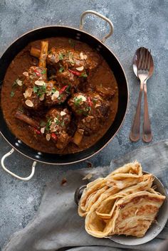 a pan filled with food next to some tortillas