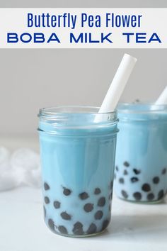 two mason jars filled with blue and black polka dot milk